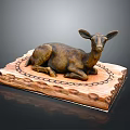 Bronze Deer Sculpture Reclining On Decorative Wooden Base With Intricate Carved Patterns