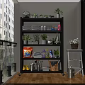 Black Metal Storage Shelf with Towels Cleaning Supplies Potted Plants and Rain Boots on Balcony