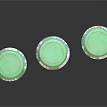 Three Glass Bottles With Green Caps And Stained Labels On Black Reflective Surface