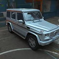 Silver Mercedes Benz G Class SUV Parked In Urban Area With Graffiti Background