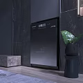 Sleek Black Washing Machine Against Dark Stone Wall With Green Plant