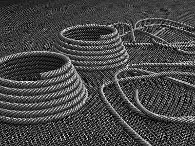 Coiled Steel Cables Placed On Black Mesh Surface Background 3d model