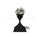 Round Coffee Table With Black Base And Vase With White And Green Flowers