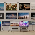 Multiple TVs Showcase Various Screen Images With Scenery And Movie Content In Showroom
