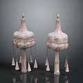 Two Traditional Sculptural Carvings With Ornate Tops Intricate Patterns And Hanging Tassels