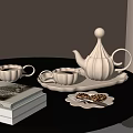 White Ceramic Tea Set With Teapot Cups Tray Cookies And Books On Black Round Table