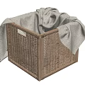 Brown Woven Storage Basket with Gray Towel Inside and Overhanging Design