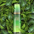 Natural Botanical Green Perfume Cosmetic Bottle With Golden Accents And Lush Plant Background