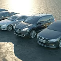 Various Modern Car Models In Lineup Along Sunlit Waterfront Area