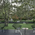 Modern Serene Residential Landscape With Lush Trees Seating Area And Art Sculpture