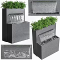 Modern Garden Accent Featuring Black Water Fountain Structure With Green Plants And Flowing Water