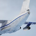 Large Military Transport Aircraft In Flight With Extended Landing Gear And Blue Stripes