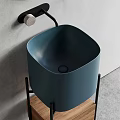 Cylindrical Blue Washbasin on Black Metal Stand with Grey Wall Background