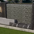 Outdoor Water Feature Wall With Stone Design Green Lawn And Pink Flowers