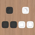 Modern Black And White Switch Panels On Wooden Surface With Light Switches And Sockets