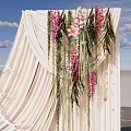 Wedding Photo Spot With Beige Drape Floral Decor And Bride In White Dress