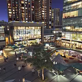 Vibrant Commercial Street Night View With High Rise Buildings Glass Facade Shops And Pedestrians