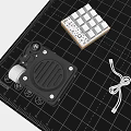 Professional Black Portable Speaker with Grille Design on Measuring Mat and Workshop Tools