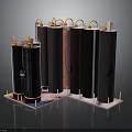Black Cylindrical Structures With Orange Pipes On Top And Pink Base Supports