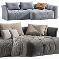 Modern Tufted Sectional Sofa With Multiple Pillows And Warm Blanket In Neutral Blue Tones 3d model
