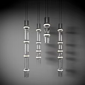 Transparent Glass Cylindrical Pendant Lights With White Ring Decorations Hanging Against Gray Background