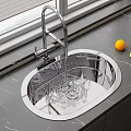 Stainless Steel Kitchen Sink With Running Water Faucet And Lemons On Countertop