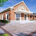 Industrial Factory Building With Red Brick Exterior White Accents Arched Windows And Entry Steps