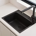 Stylish Black Quartz Kitchen Sink With Modern Faucet On White Countertop