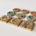 Various Jewelry Pieces Including Bracelets And Necklaces On Wooden Trays With Colorful Beads