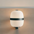 Stylish Modern Wall Lamp Featuring White Shade Black Horizontal Band On Wooden Wall