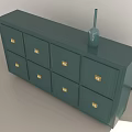 Green Cabinet With Golden Handles And Eight Drawers By Window With Vase