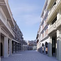 Traditional Commercial Street With Classical Architecture Arched Doors And Stone Pavement