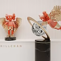 Red Winged Sculptures with Golden Wings Silver Ring and Black Marble Base