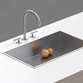 Stainless Steel Kitchen Sink With Modern Faucet And Two Eggs On White Countertop