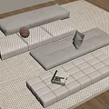 Beige Modular Sofa Set With Cushions On Woven Rug And Book
