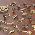 Brass Handles In Various Styles Displayed On Wooden Background Surface