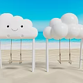 Cloud Shaped Swings With Smiling Face And Round Design On Seaside Beach