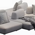 Large Gray Sectional Sofa with Multiple Plush Pillows and Soft Blanket for Cozy Living Room