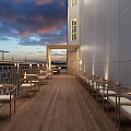 Restaurant Outdoor Terrace Featuring Wooden Flooring Arranged Tables Chairs White Walls River View Blue Sky