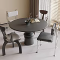 Modern Black Round Dining Table and Chairs Set In Room With Window Vase and Book