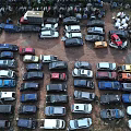 Parking Lot With Many Cars Of Different Colors And Models Parked Closely