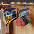 Pink Knit Hat with Bear Embroidery and Colorful Socks on Blue Hangers in Closet