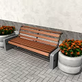 Public Bench With Wooden Seat And Concrete Base Near Colorful Flower Pots On Paved Ground