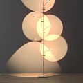 Modern Floor Lamp With Multiple Curved Arms And Circular Light Shadows On Wall