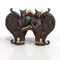 Dark Colored Carved Decorative Sculpture With Demon Figures Holding Green Object And Small Human Statues