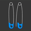 Two Shiny Silver Safety Pins With Blue Heads On Dark Background