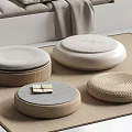 Soft Gray Pillow on White Bench with Gray Blanket and Woven Floor Cushions