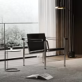 Modern Leisure Chair With Black Leather And Metal Frame Near Glass Window And Side Table