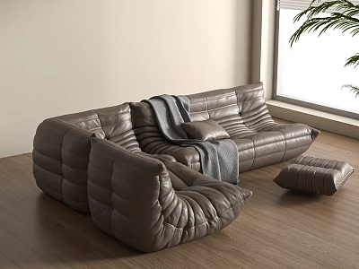 Gray Leather Sectional Sofa With Throw Blanket And Ottoman On Wooden Floor With Natural Light 3d model