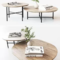Modern Round Wooden Coffee Table With Black Metal Legs And Decorative Books Plant